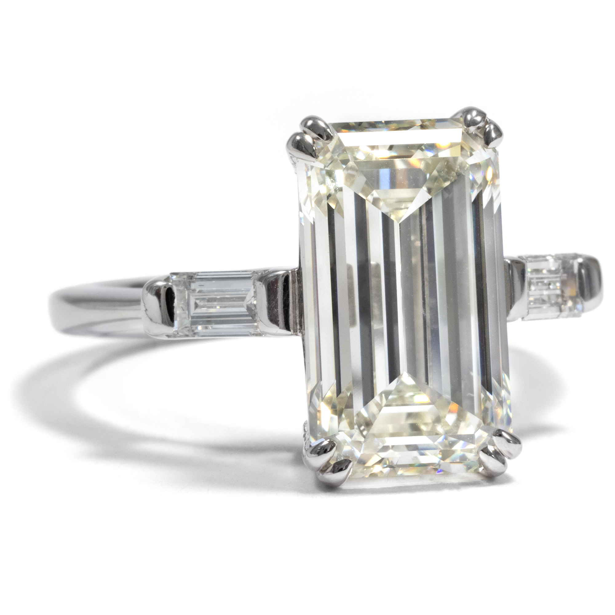 First class 5.30 ct emerald cut diamond in a white gold ring, ca. 2010